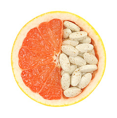 Image showing Close up of red grapefruit and pills isolated