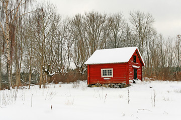 Image showing Traditional Swedish red wooden house in snow