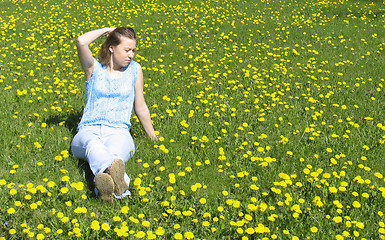 Image showing Girl on dandelion lawn