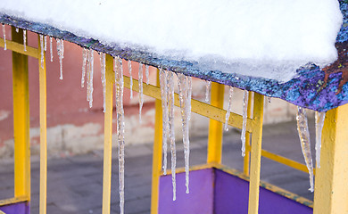 Image showing Melting icicles spring on roof playground house. 