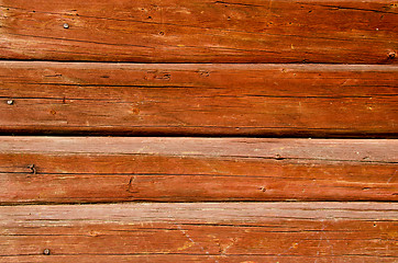 Image showing Background of shaved log wall rusty nail heads 