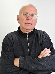 Image showing senior man with glasses  and hands crossed on  chest