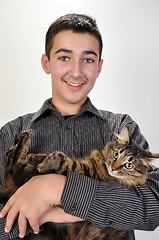 Image showing smiling teeage boy with a cat