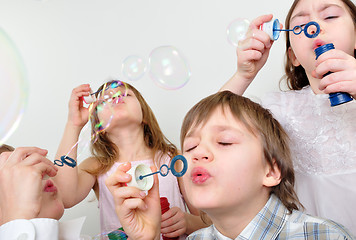 Image showing children firends blowing bubbles