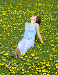 Image showing Girl on dandelion lawn