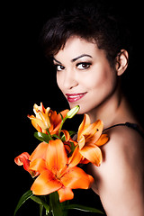 Image showing Young Beautiful Woman Holding Lily Flowers