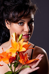 Image showing Young Beautiful Woman Holding Lily Flowers