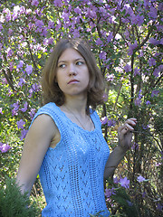 Image showing Girl and rhododendron in blossom