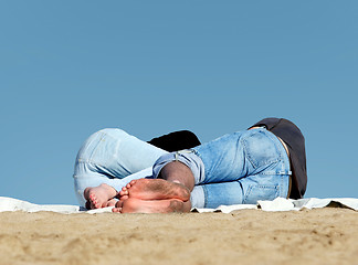 Image showing Couple sleeping on the beach