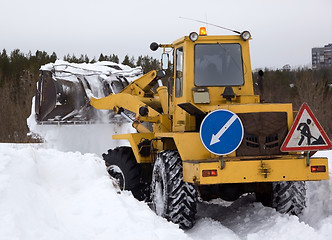 Image showing The tractor clears snow from the road blockage