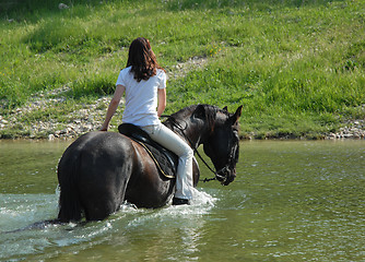 Image showing riding woman in river
