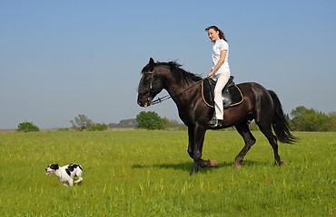 Image showing riding girl and her dog
