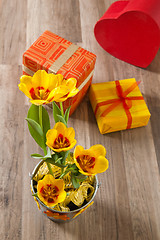 Image showing It is red yellow tulips and gift boxes, a close up