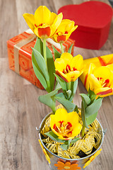 Image showing It is red yellow tulips and gift boxes, a close up