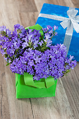 Image showing Spring bouquet  campanula blue and gift box, a close up