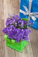 Image showing Spring bouquet  campanula blue and gift box, a close up