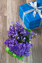 Image showing Spring bouquet  campanula blue and gift box, a close up