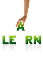 Image showing Hand holding letter A of word Learn
