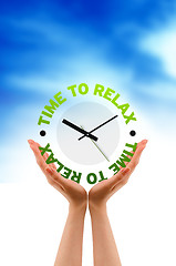 Image showing Hands holding a relax clock