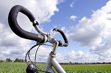 Image showing Bicycle handlebar on cloudy sky. No fuel needed 