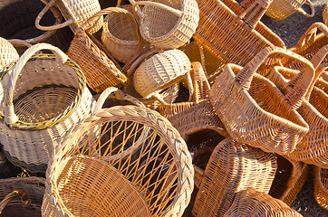 Image showing Handmade basket bags stacked pile sell fair market 