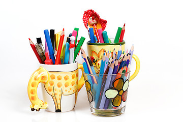 Image showing pen holders  with colored pens on a white background 