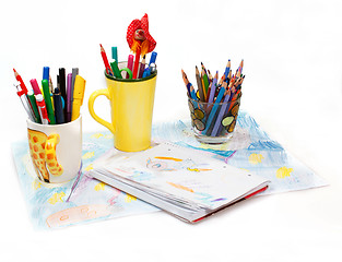 Image showing Abstract painting  and pen holders  with colored pens