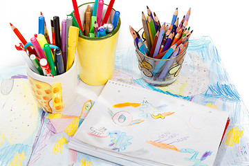 Image showing Abstract painting  and pen holders  with colored pens