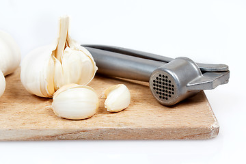 Image showing Fresh garlic and chrome steel press