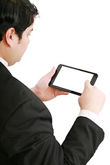 Image showing Businessman holding a blank touchpad pc, one finger touches the 