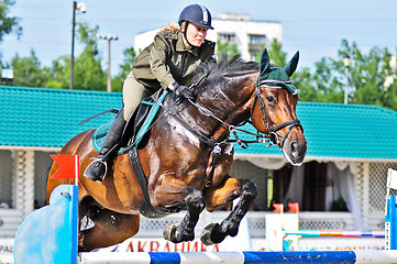 Image showing Female rider on jump horse