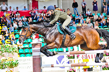 Image showing Female rider on jump horse