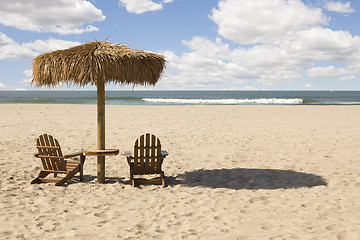 Image showing Two Beach Chairs and Umbrella on Beautiful Ocean Sand