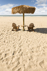 Image showing Two Beach Chairs and Umbrella on Beautiful Ocean Sand