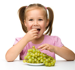 Image showing Little girl is eating grapes