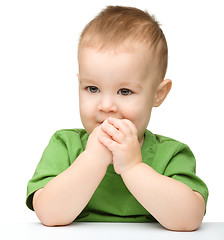 Image showing Pensive little boy support his head with hand