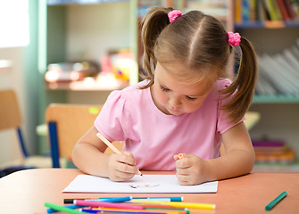 Image showing Cute little girl is drawing with felt-tip pen