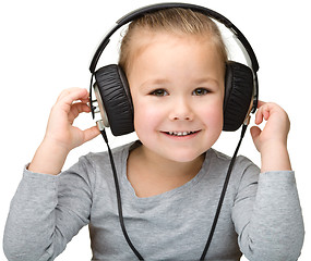 Image showing Cute girl enjoying music using headphones