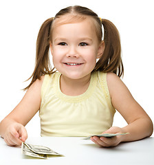 Image showing Cute little girl with paper money - dollars