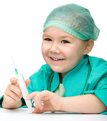 Image showing Cute little girl is playing doctor with syringe