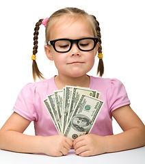 Image showing Cute cheerful little girl with paper money