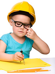 Image showing Little girl play with divider wearing hard hat