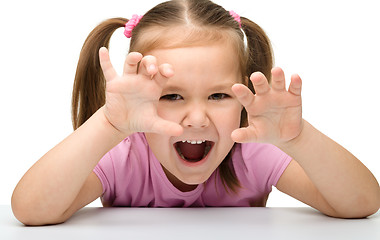 Image showing Cute little girl is showing a tiger