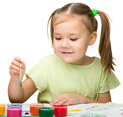 Image showing Cute cheerful child play with paints