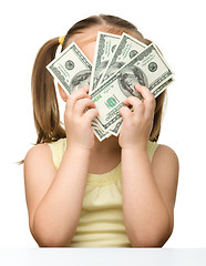 Image showing Cute little girl with dollars