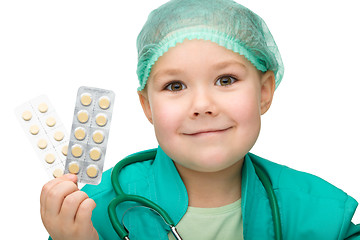 Image showing Cute little girl is playing doctor with pills