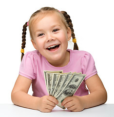 Image showing Cute little girl with paper money - dollars