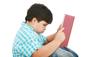 Image showing Young boy tries to do his homework 