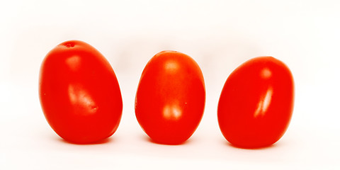 Image showing Three tomatoes isolated against white background 