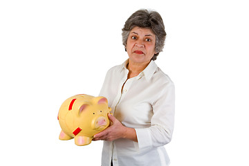 Image showing Female senior with piggy bank